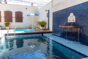 a swimming pool in a house with a swimming pool at Pousada Boulevard in Cabo Frio