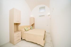 Llit o llits en una habitació de La Piazzetta Boutique Apartments