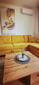 a living room with a couch and a coffee table at Apartman VARENICA in Doboj