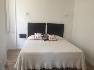 a bedroom with a bed with two pillows on it at Douro - A Casinha da Ana in Vila Real