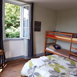 a bedroom with a bunk bed and a window at Chambres d'hotes Condat in Condat-sur-Ganaveix