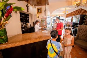 a group of people standing at a counter in a restaurant at Hotel del Carmen, en el Centro- DESAYUNO Incluido ! in Tuxtla Gutiérrez