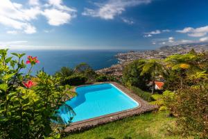 a swimming pool with a view of the ocean at Atlantic Ocean view by HR Madeira in Funchal