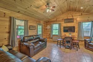 a living room with leather furniture in a log cabin at Rustic Mtn-View Cabin Less Than 1 Mile to White River! in Mountain View