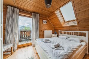 מיטה או מיטות בחדר ב-Ferienhaus Panorama