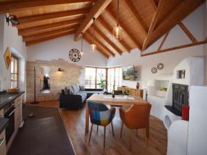 a kitchen and living room with a table and chairs at Bosch Hermann in Grassau