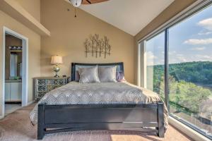 a bedroom with a bed and a large window at Osage Beach Condo with Shared Pool and Lake Views! in Osage Beach +17 photos