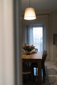 a dining room table with a potted plant on it at Kalos Casa Vacanza in Salice Salentino