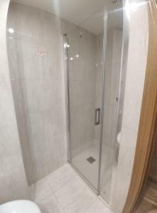 a shower with a glass door in a bathroom at Apartamento Libertad in Jaca
