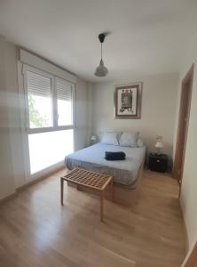 a bedroom with a bed and a table in it at Apartamento Libertad in Jaca