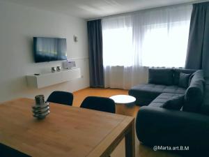 a living room with a couch and a table at Milonia 3 in Bernkastel-Kues