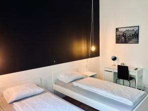 a hotel room with two beds and two lamps at Bohem Prague Hotel in Prague