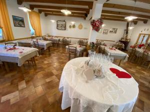 a dining room with tables with white tablecloths at Al Castello in Artegna