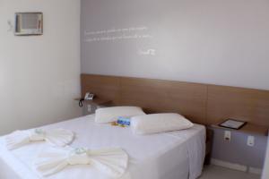 Postel nebo postele na pokoji v ubytování Hotel Abrolhos + 17 fotografií