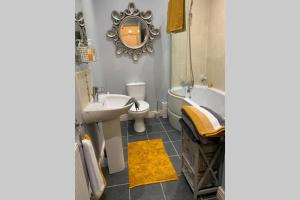 a bathroom with a sink and a tub and a toilet at Sperrin View Apartment (Ground Floor) in Draperstown