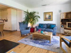 a living room with a blue couch and a coffee table at Ferienhaus Birdy in Blieskastel