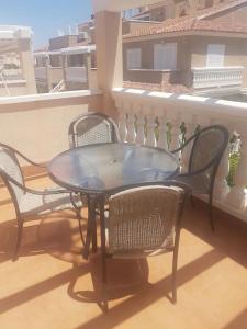 a black table and chairs on a balcony at Inviting 2-Bed Apartment 5 minutes to the beach in Punta Prima