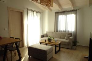 a living room with a couch and a table at Vasiliki Residence in Pylos
