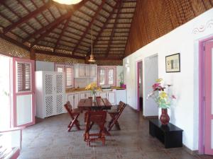 a kitchen with a table and chairs in a room at Las Puertas del Paraíso in Río San Juan +56 photos