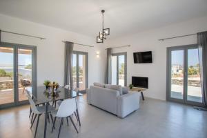 a living room with a couch and a table at Bluebell Resort Villa SUNSET in Kampos Paros