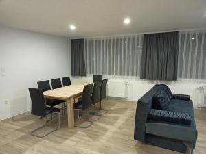 a conference room with a wooden table and chairs at APARTMAJI KISILAK in Rogašovci