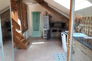 a kitchen with a sink and a staircase in a house at Villa Sauna Tout Confort Pleine Campagne in Ladon