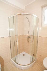 a shower with a glass enclosure in a bathroom at Villa Angel in Kamenari