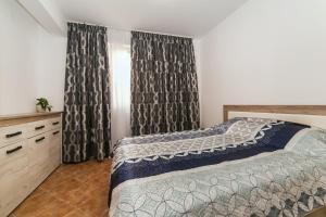 een slaapkamer met een bed en een raam met gordijnen bij Villa Angel in Kamenari