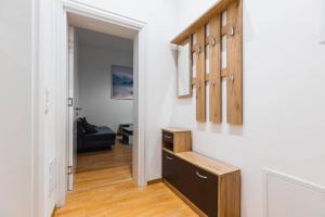 a hallway leading to a living room with a stairway at Family apartment next to Danube river in Vienna