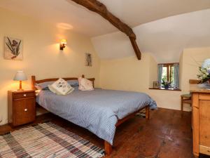 a bedroom with a bed with two pillows on it at Bell Buoy Cottage in Bude