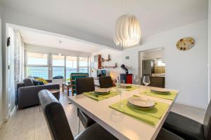 a dining room and living room with a table and chairs at Apartment Seaside in Zaboric
