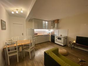 a kitchen with a table and a dining room at Holiday Home - Boanerges Heritage in Blato na Cetini