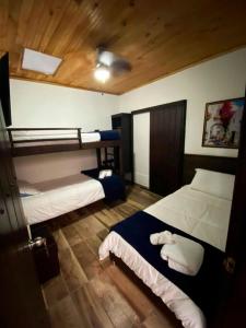 a bedroom with two beds and a wooden ceiling at Hotel Boutique Colonial Cartago in Cartago