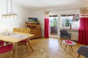 ein Wohnzimmer mit einem Tisch und Stühlen sowie ein Esszimmer in der Unterkunft Ferienwohnung Arzgrube in Mittenwald