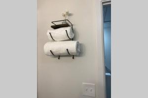 a stack of towels hanging on a wall next to a mirror at Trendy Renovated House/ Get Away to Downtown Norcross in Norcross