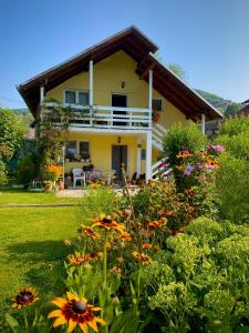a yellow house with flowers in front of it at Family Flower House in Sarajevo