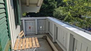 a porch with a bench on a house at Ferienwohnung "Birkenstrasse" in Bad Wiessee