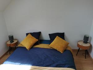 a bedroom with a bed with two side tables at L'opale in Le Bourg-dʼOisans