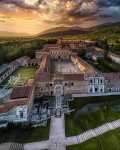an aerial view of a large building with mountains in the background at B&B NONNO MICHELE in Padula