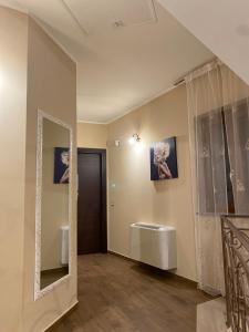 a bathroom with a mirror and a sink at B&B NONNO MICHELE in Padula