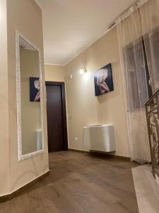 a room with a mirror on the wall and a door at B&B NONNO MICHELE in Padula +28 photos