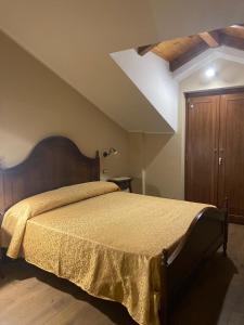 a bedroom with a large bed with a wooden headboard at B&B NONNO MICHELE in Padula