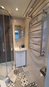 a bathroom with a sink and a shower at Anita's center apartment in Liepāja