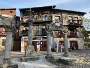 an old building with pillars in front of it at Hostal La Alberca in La Alberca