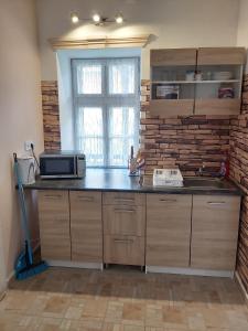 A kitchen or kitchenette at Sweet Home Apartman Szilvásvárad