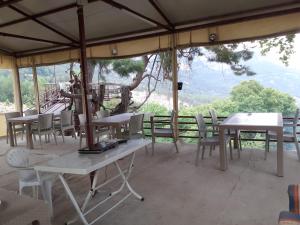 a group of tables and chairs under an umbrella at BEYCIK PANORAMA CAMPING in Kemer