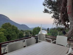 a table and chairs on a balcony with a view at BEYCIK PANORAMA CAMPING in Kemer