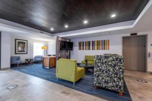 a living room with a couch and a table and chairs at Holiday Inn Express Hotel & Suites Petersburg/Dinwiddie, an IHG Hotel in Petersburg