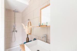 a bathroom with a sink and a shower at BLUE WAVE - 2 bedrooms - Orient Beach! in Orient Bay +26 photos