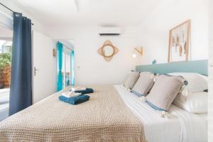 a bedroom with a large bed with a blue headboard at BLUE WAVE - 2 bedrooms - Orient Beach! in Orient Bay